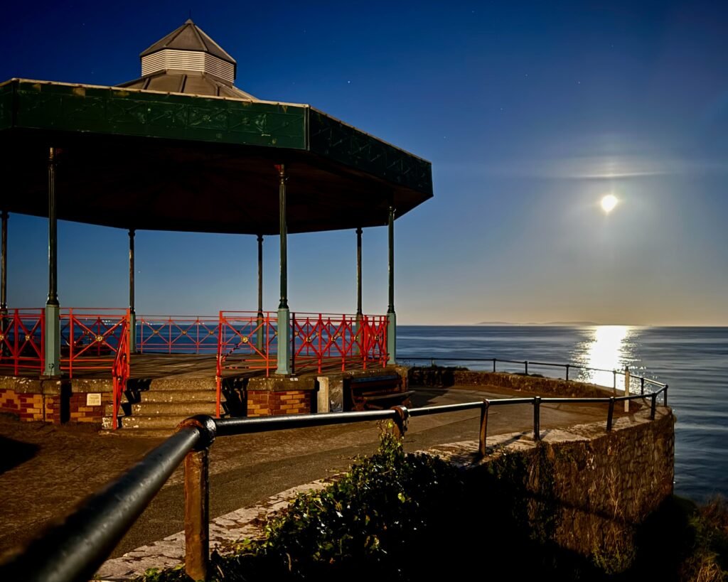 Castle Hill bandstand in Tenby, lit up by the Harvest Moon, Pembrokeshire, Wales