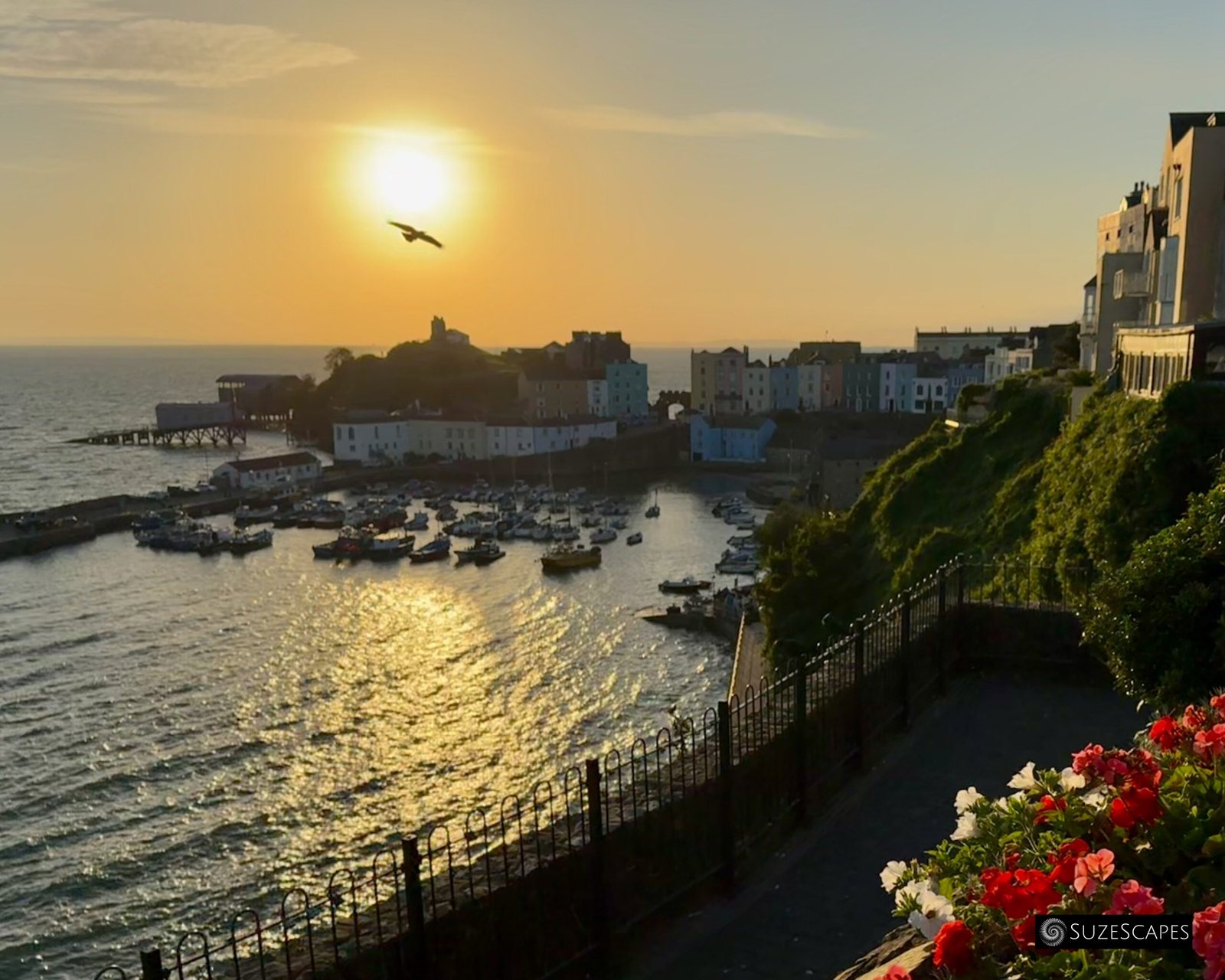 Sun rising above Castle Hill in Tenby, Pembrokeshire, Wales