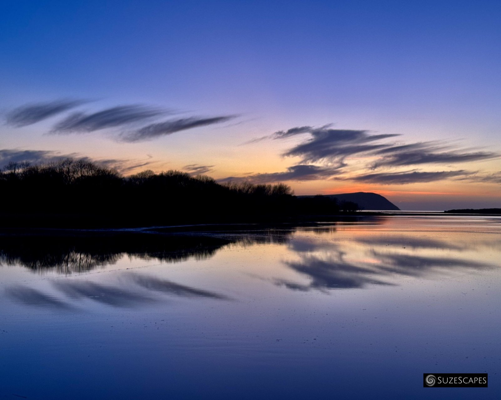 Twilight reflections on Newport Estuary, Pembrokeshire, Wales